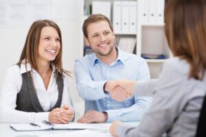 Happy couple with bank employee