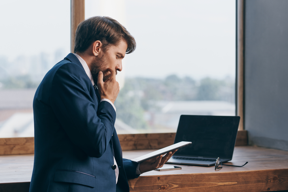 Business executive examines tablet methods