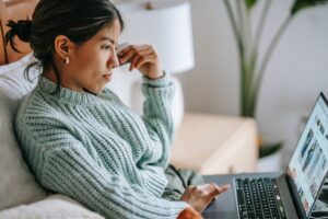 Woman looking at online shop on laptop