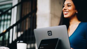 Cashier smiling at customer across counter