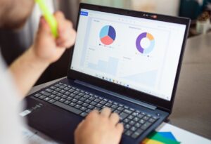 Looking at NPS donut and pie charts on laptop